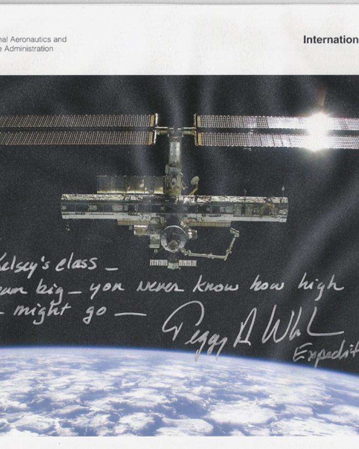 An image of the ISS with a note scrawled on top. 