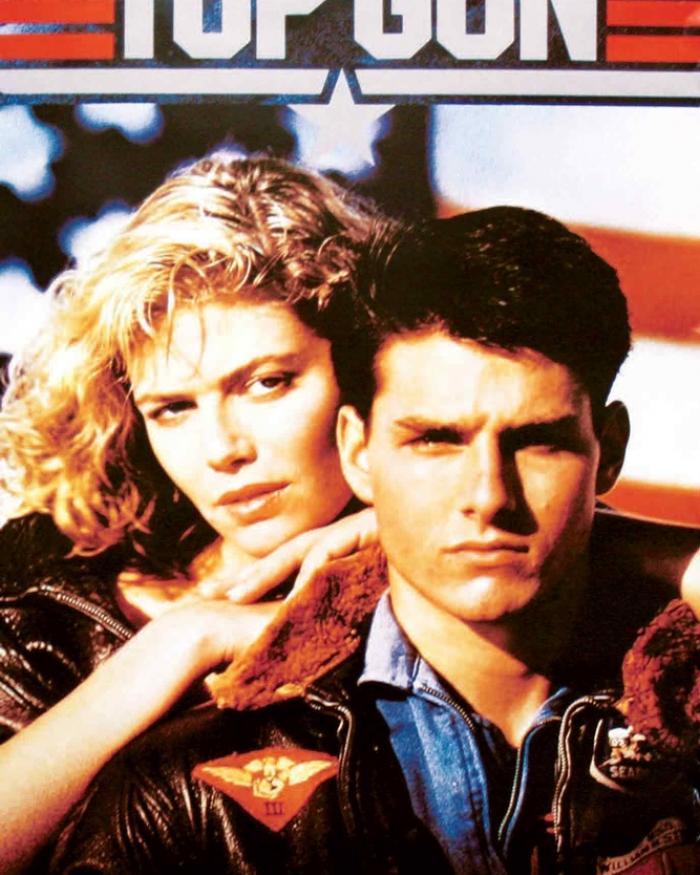 A man and a woman stare into a camera in front of a star-spangled background.