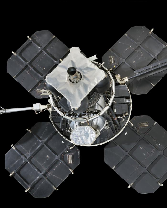 Lunar lander with four square solar panels attached to central instrument box and round satellite dish