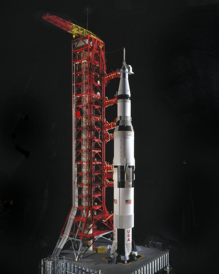 Scale model of black and white Saturn V Rocket with launch pad