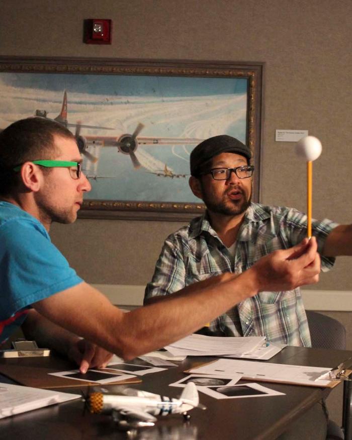 Two middle school science teachers explore a Moon phase activity during the STEM Institute for Educators at the Museum in 2016