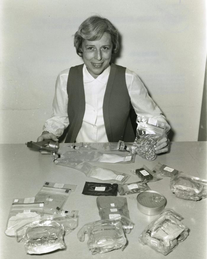 Rita Rapp displays the range of food containers used on the Apollo 16 mission