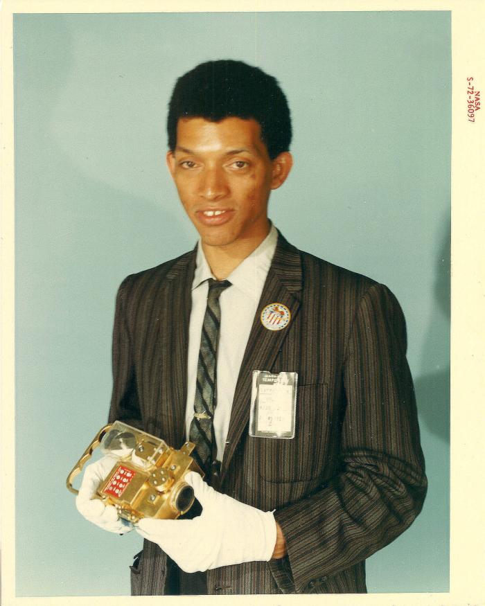 Portrait of Carruthers holding film transport. 