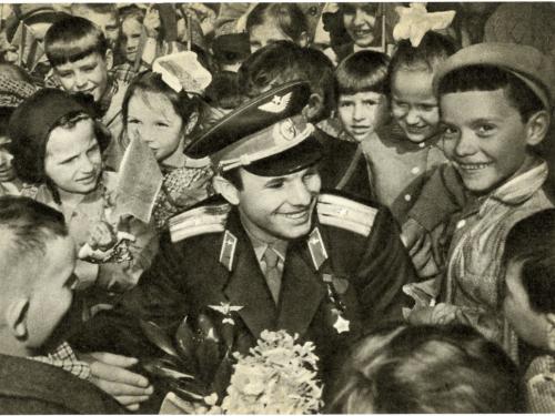 Soviet cosmonaut Yuri Gagarin surrounded by a crowd of children