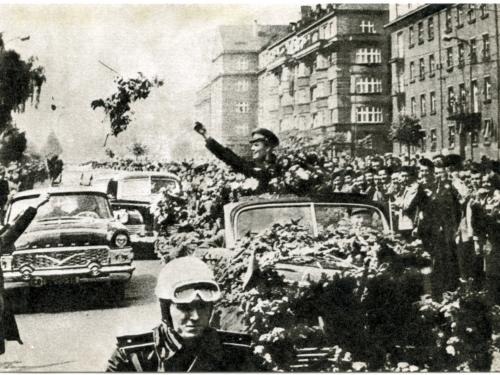 Soviet cosmonaut Yuri Gagarin waves to crowds at parade