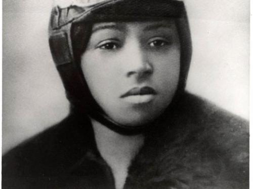 Portrait of Bessie Coleman with a pilot headgear and goggles