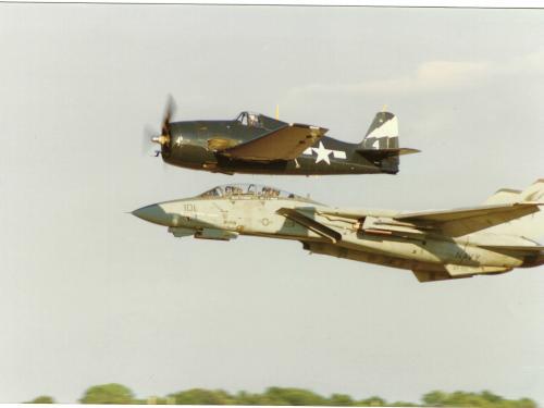  An F-14 Tomcat and F6F Hellcat flying in formation