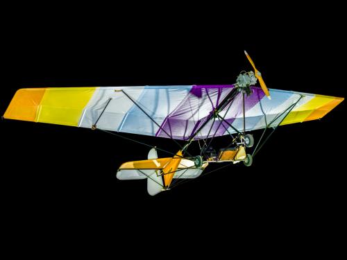 View of a undercarriage of a glider. The background of the image is black.