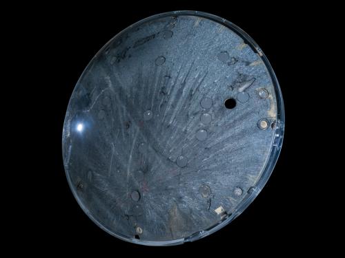 Underside view of a space capsule. The background of the image is black. 