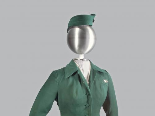 A photograph of a green colored uniform on a mannequin.