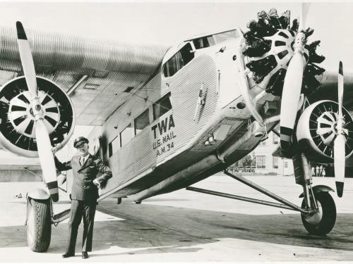 Transcontinental and Western Air Pilot Arthur Burns standing in front of a Ford 5-AT Tri-Motor