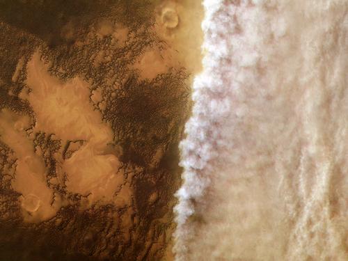 Aerial View of dust cloud moving across the surface of Mars