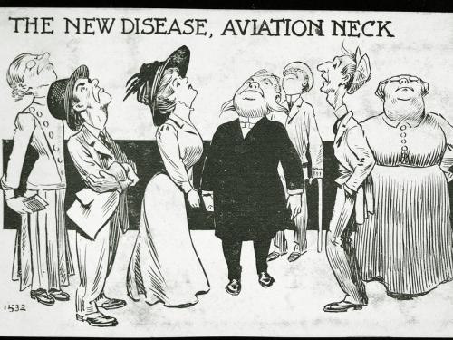 Seven people crane their necks toward the sky, their heads presumably looking up at a passing airplane.