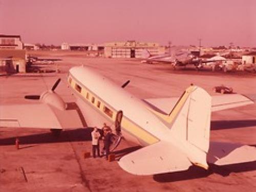 A photo taken from behind the tail of the plane, providing a three-fourths view of the plane from behind. The plane looks similar to a commercial airliner.