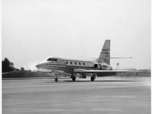 A mid-sized jet airplane landing on the runway.