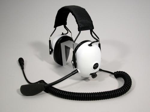 Headphones with white earmuffs and a microphone.