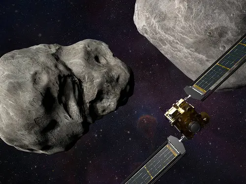 Artist rendering of DART spacecraft near two asteroids 