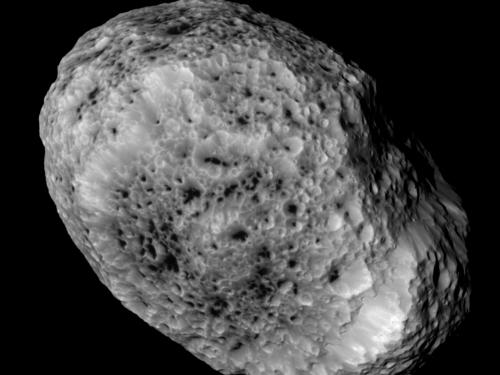 An oval shaped asteroid covered in crater marks.