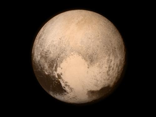 An image of Pluto with a large heart shape on it in the bottom right.