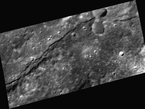 A scarp, or steep cliff, extends horizontally through this image of Mercury's surface.