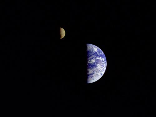 An image of the Earth and the Moon next to each other, the Moon just slightly to the northwest of the Earth. Only the right half of each body can be seen.