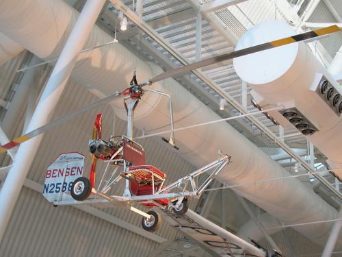 What looks like a seat with a small rudder and with two giant blades suspended above it. 