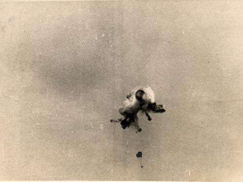 Sepia toned vintage image of view of an observation balloon being shot down. over