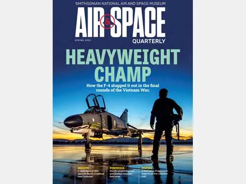 Pilot silhouetted in front of fighter jet.