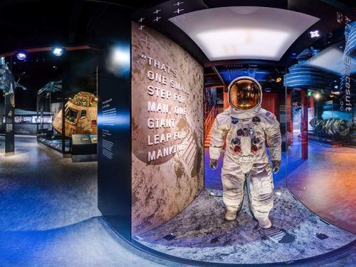 A panoramic view of Destination Moon, featuring Neil Armstrong's spacesuit and the Command Module Columbia.