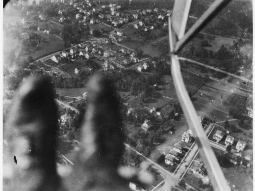 A photo taken looking down at Earth. Blurry boots can be seen in the corner of the frame. 