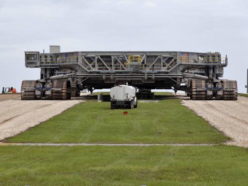 Giant mobile launch crawler on roadway.