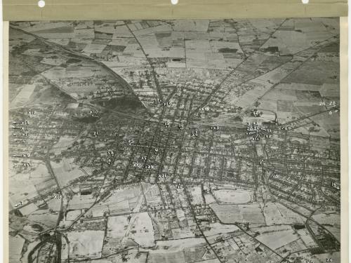 Aerial view of a town with numbers and arrows marking plant locations