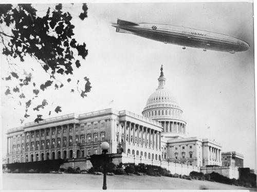 A photo of the USS Shenandoah flying over the Capitol dome.