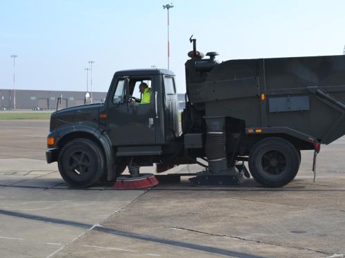 A truck sweeps on a runway.