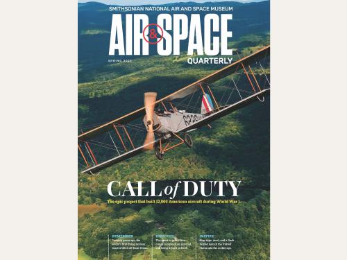 The cover of Air & Space Quarterly shows a historic biplane flying over a forest, it's propellor spinning rapidly in a blur. 