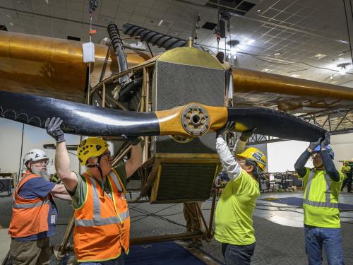 Contractors removing propeller from a plane