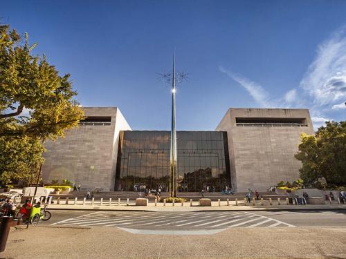 View of the front entrance and large narrow sculpture of the National Air and Space Museum's building in Washington, D.C.