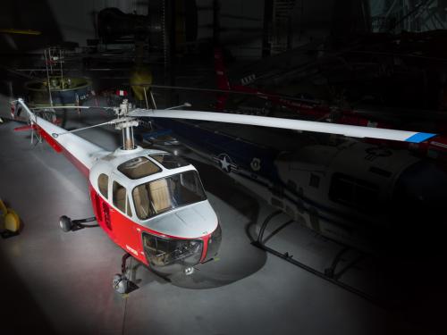 View of a red and white helicopter inside of the museum. 