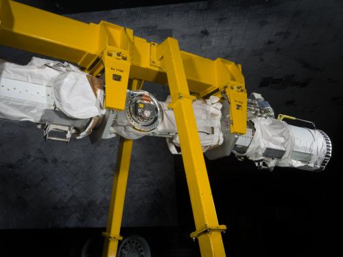 Robotic arm attached to a support beam. 