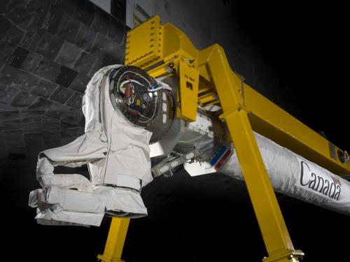  Robotic arm attached to a support beam. 