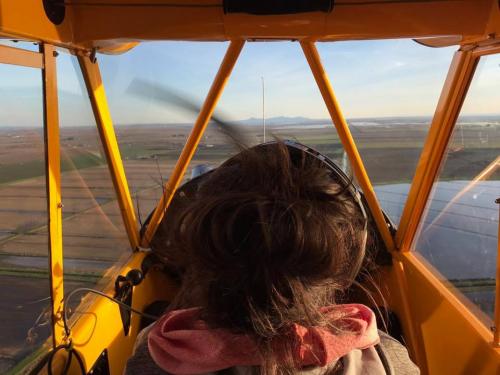 A photo of Ariel Tweto piloting an airplane