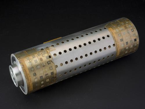 Metal cylindrical tube with small circular holes and tape on edges