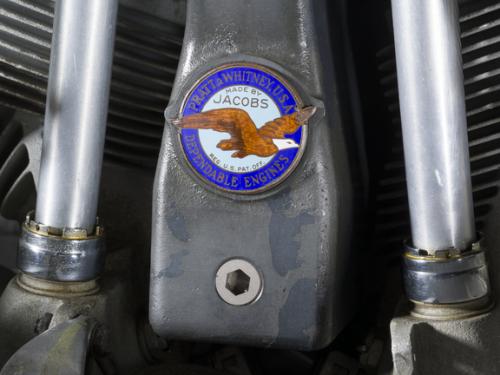 Close up view of a Pratt & Whitney logo on a propeller attached to an engine of a plane.