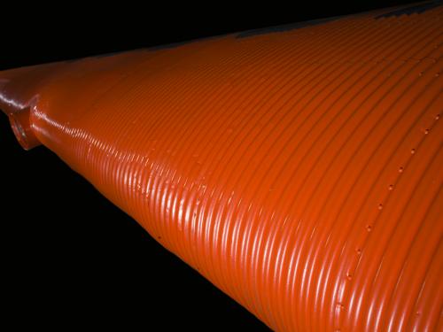 Close up image of an orange wing and light of a plane.