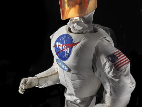 Upper body of a robot with arms, chest with a NASA logo, and an orange face cover.