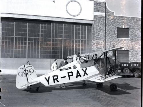 Profile of the Jungmeister with Olympic rings on the tail. Black and white photo. 