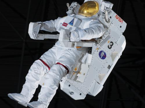 View of the front of a spacesuit. The suit has a propulsion backpack attached to it.