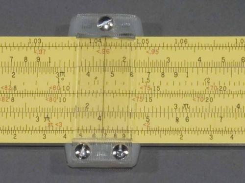 Yellow painted aluminum slide rule, with ruled markings on both sides, Plastic cursor.