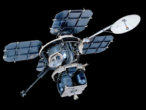 Four square solar panels constructed of aluminum frames and composite solar collectors, attached to a central body via aluminum struts. The Central bus consists of a variety of solid boxes and stalks with panels and other objects projecting from it. A tubular mast at the apex of the frame supports a rectangular a circular high gain antenna. A selection of instrument boxes, vernier rockets and their fuel containers, and the TV camera are attached to the frame.