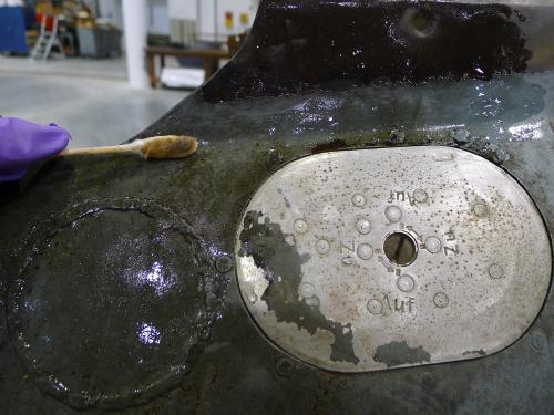 A section of the Horten Ho 229 V3 has had stains partially removed so that it resumes its original color.